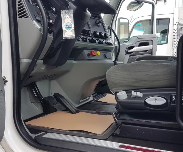 Cleaned Kenworth semi truck interior driver seat and floor mat after mobile detailing in Calgary